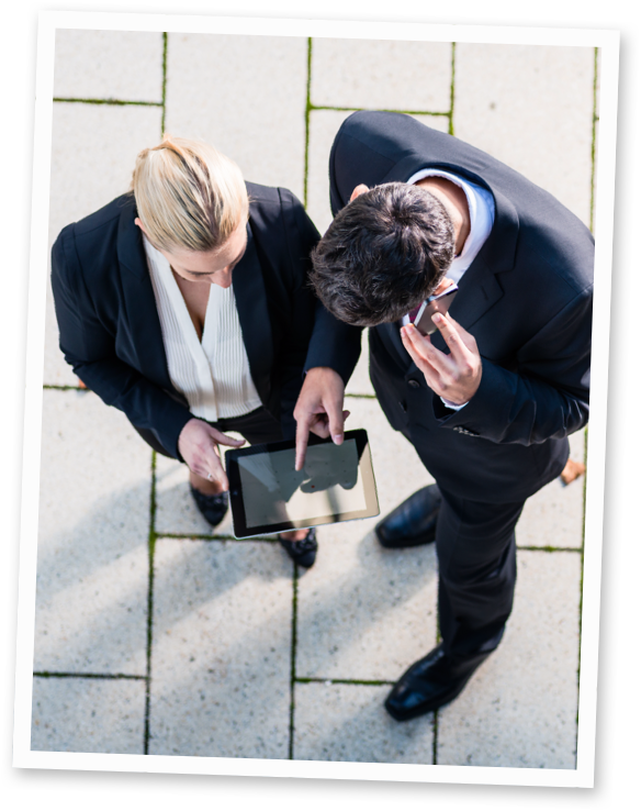 Two people looking at a tablet